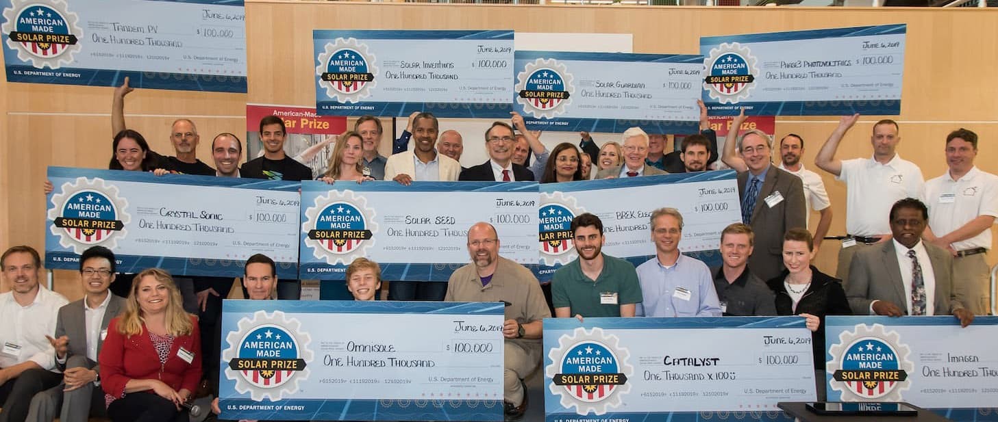 solar prize winners holding their checks